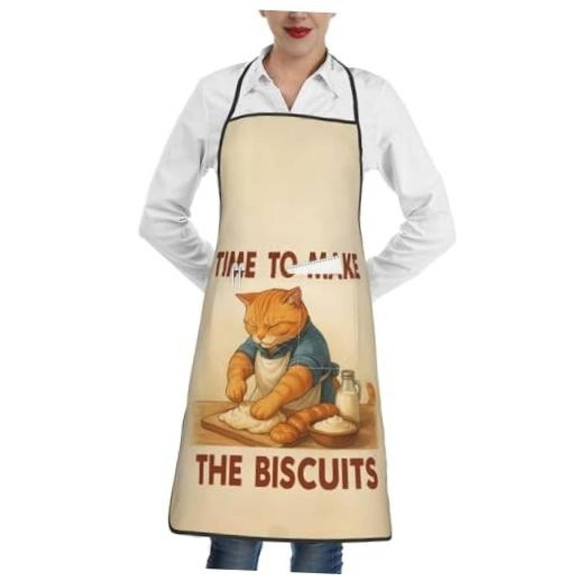 Beige chef bib apron worn over white shirt; cat baking and biscuits print