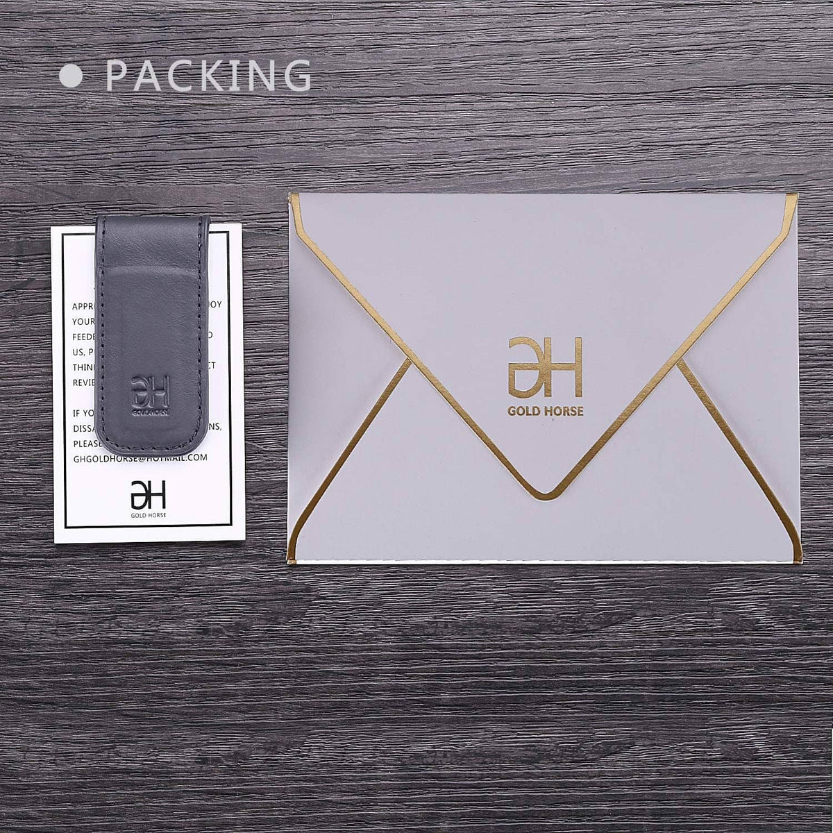 Grey leather magnetic money clip with EH logo, shown with branded envelope and pouch