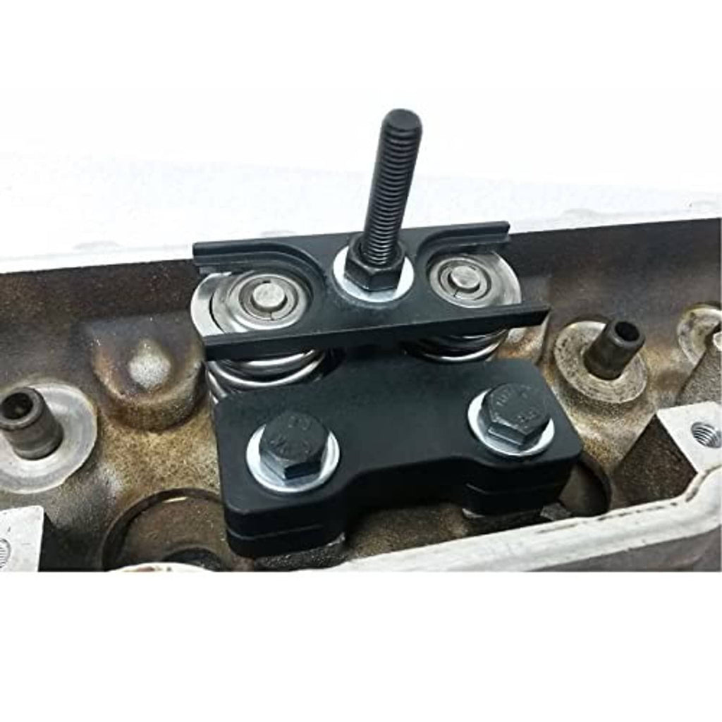 Valve spring compressor tool clamped on engine valve retainer, showing screw tension bolt