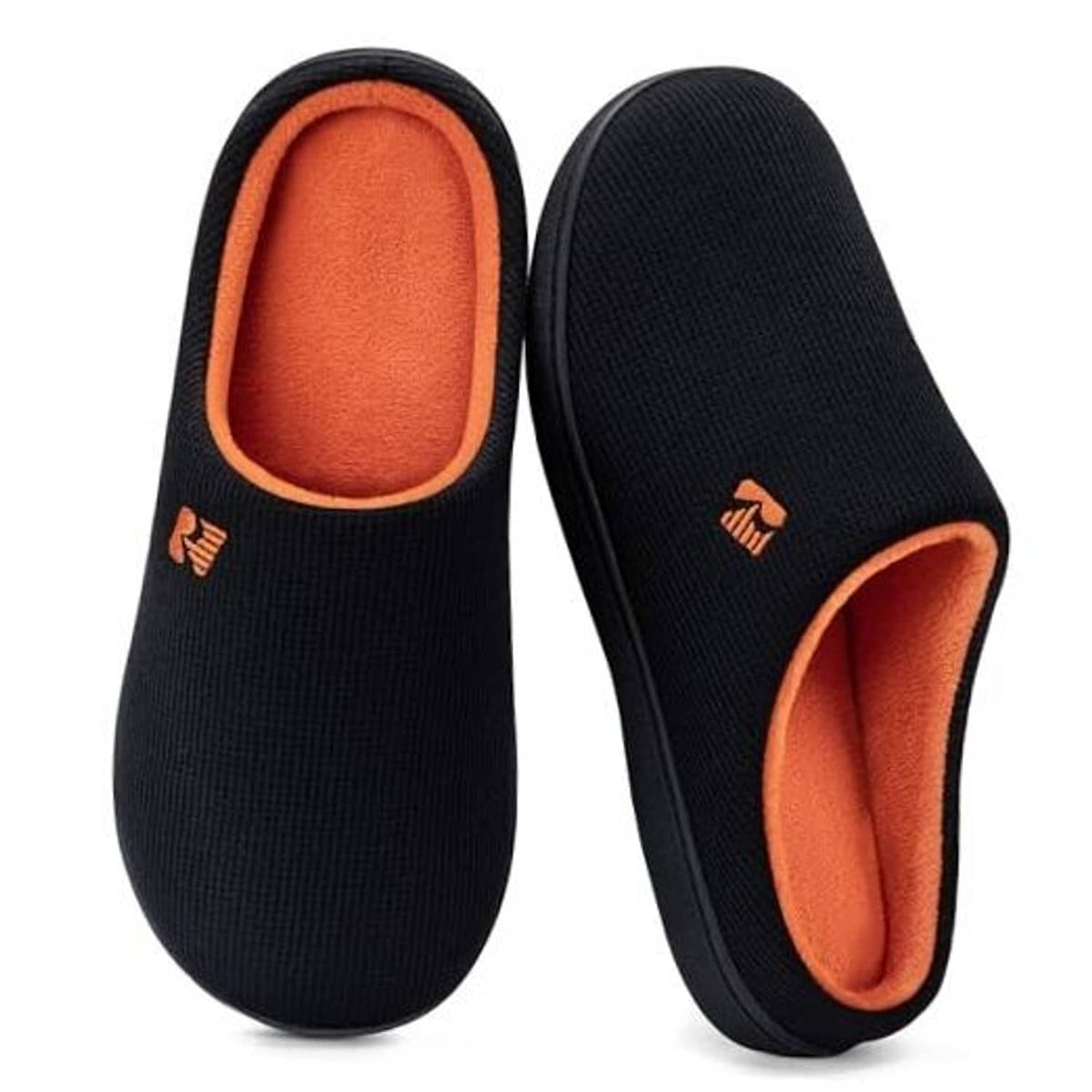 Two-tone black memory foam slippers with orange lining and slip-on design