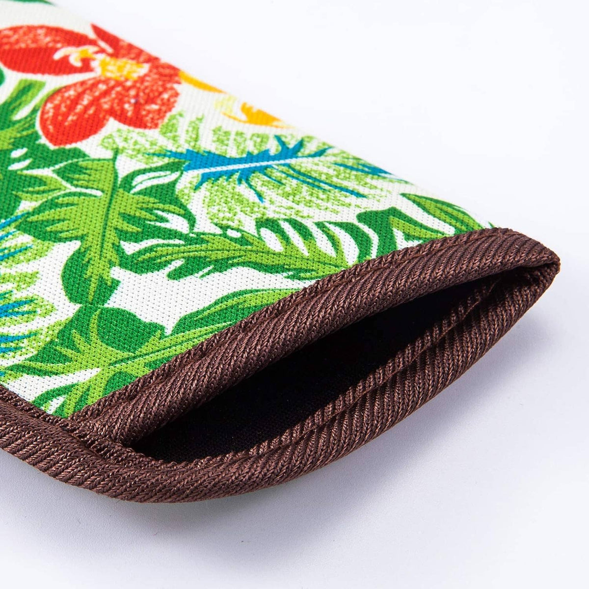 Folded slim eyeglasses pouch with tropical leaf print and brown stitched edges