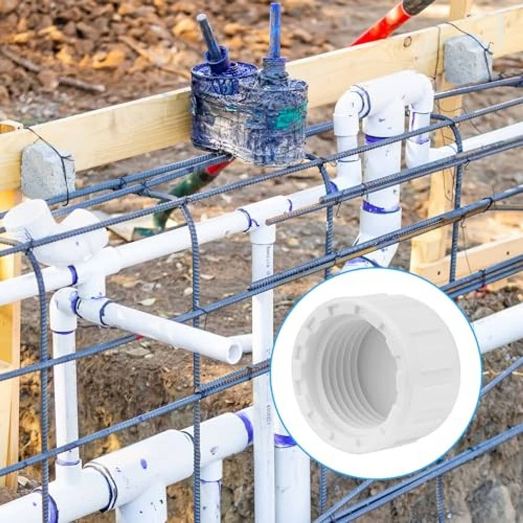 White PVC sprinkler caps covering pipe ends with 1/2-inch female threads