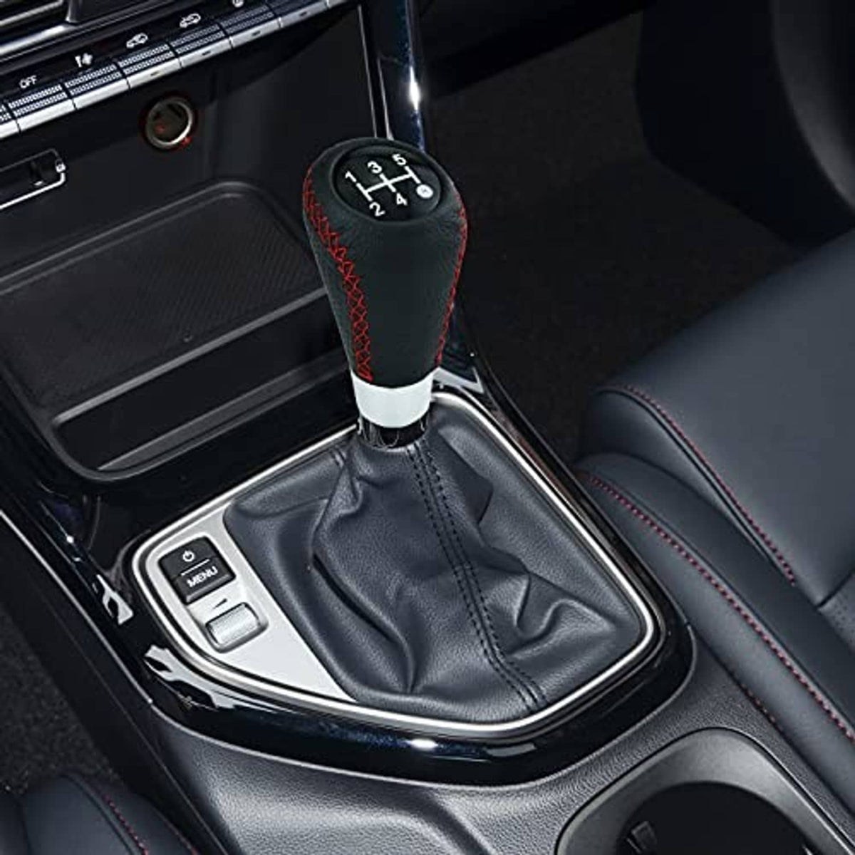 Leather 5-speed gear shift knob installed in car console, black with red stitching and white base
