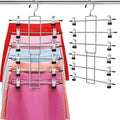 Chrome pants hanger rack with clips holding folded pants in a row