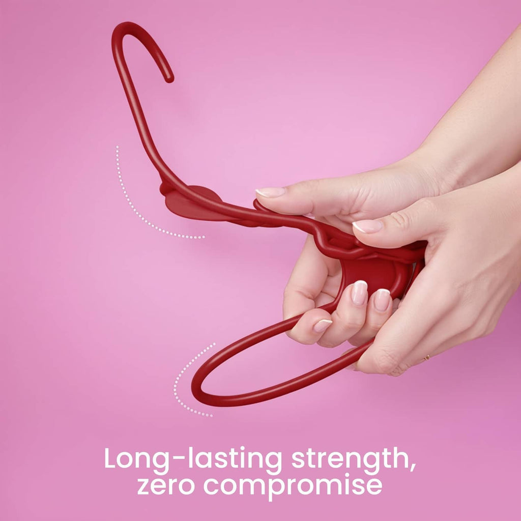 Red plastic clothes hanger with curved hook and strong frame, held in hands