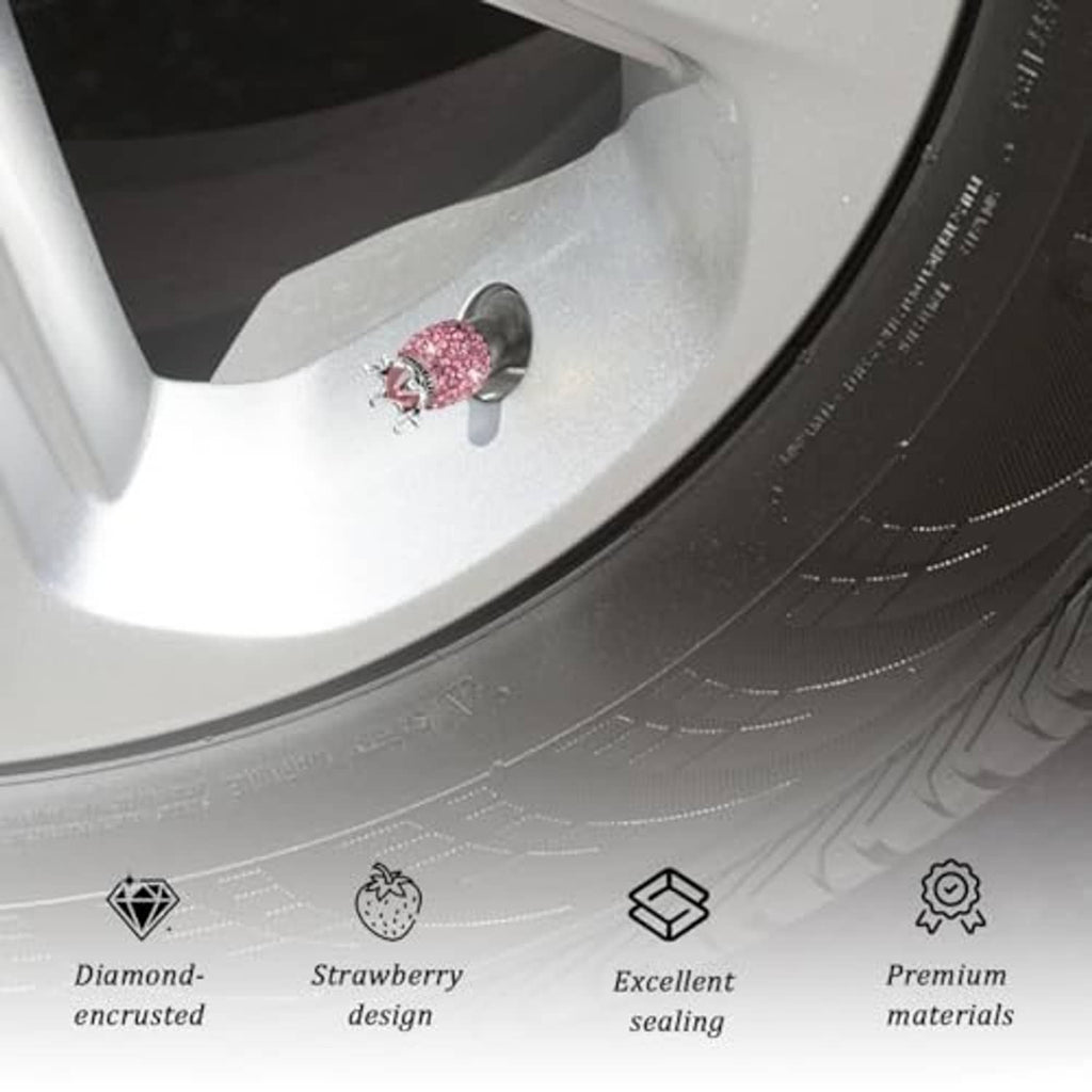 Pink rhinestone crown valve stem cap on a wheel rim, silver crown and black opening