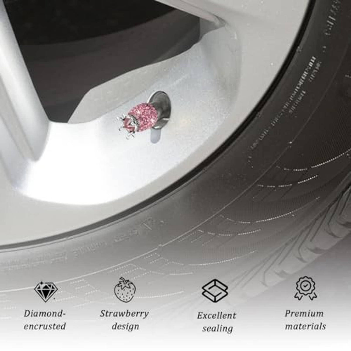 Pink rhinestone crown valve stem cap on a wheel rim, silver crown and black opening