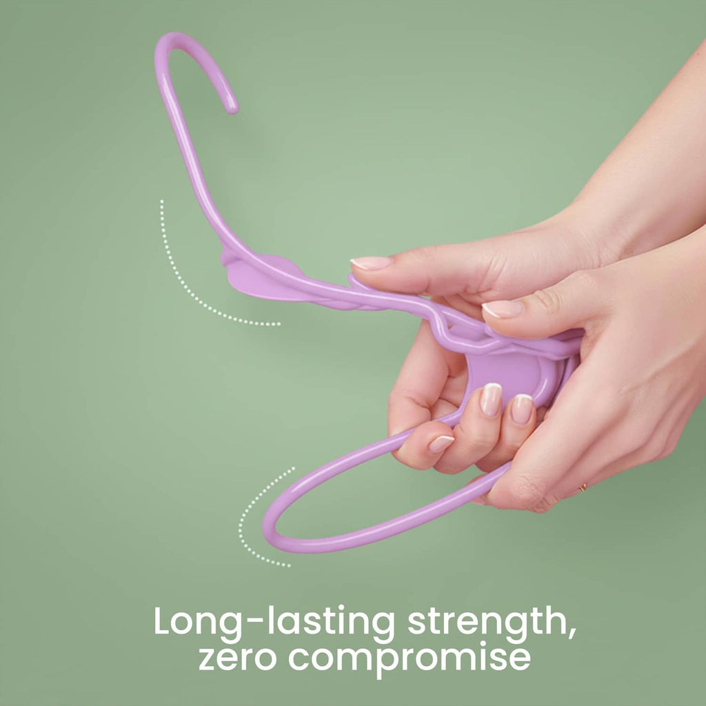 Pink plastic hanger held in hand, curved hook and smooth frame