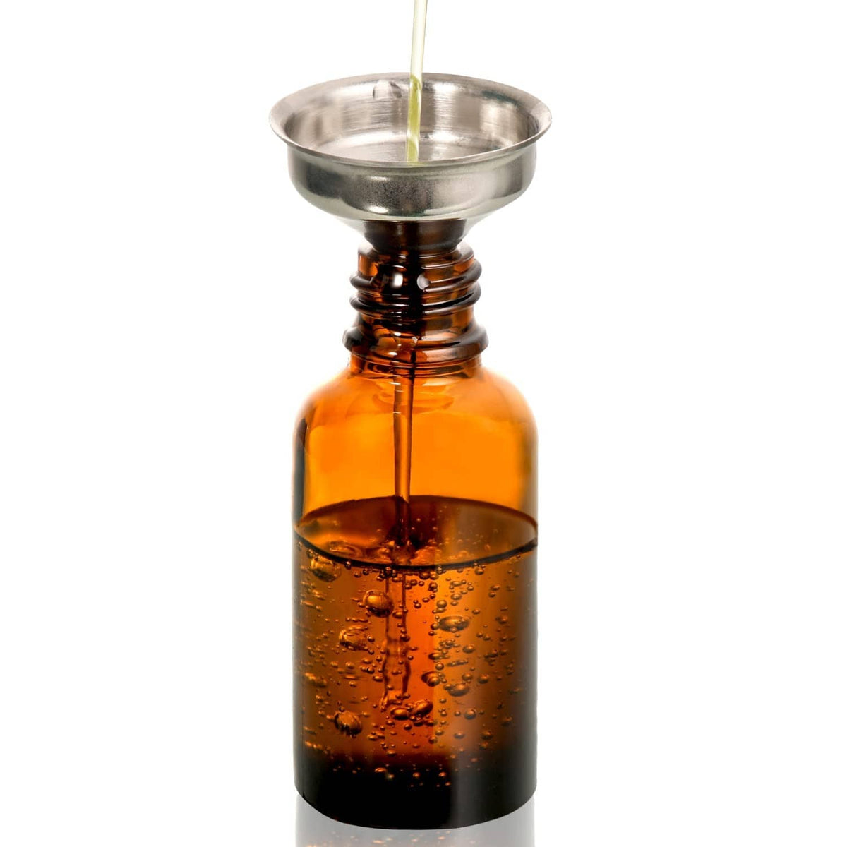 Amber glass bottle with metal funnel and clear dropper pipette dispensing liquid