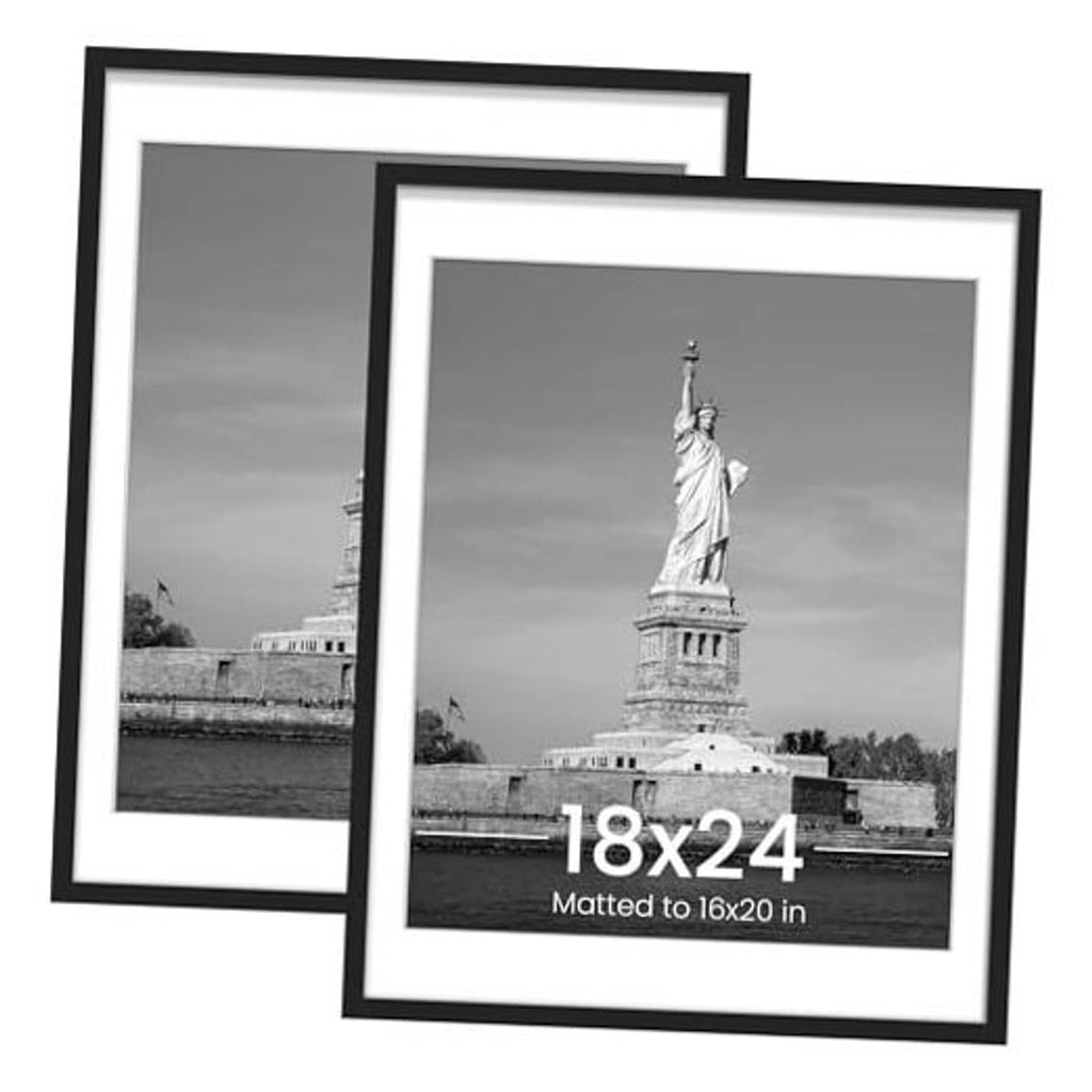 Black picture frame with white mat, holding a monochrome poster print