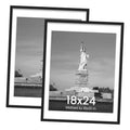 Black picture frame with white mat, holding a monochrome poster print