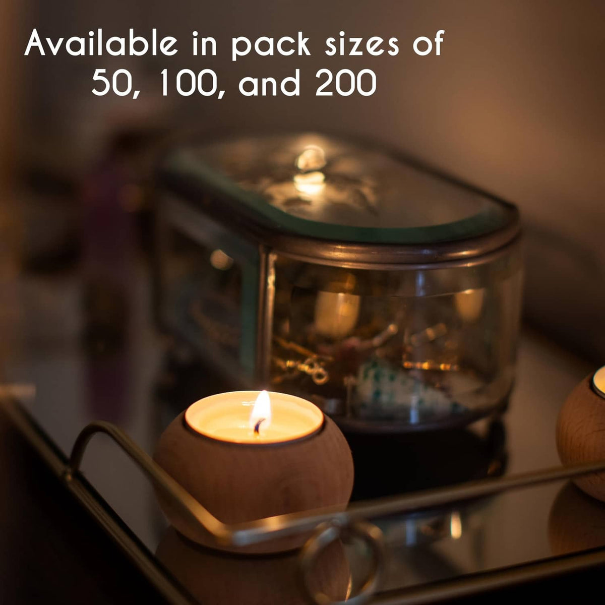 White unscented tea light candle with flame in a small cup on a metal tray
