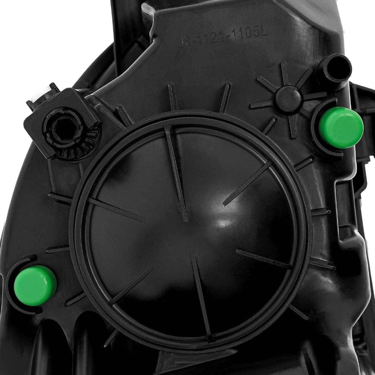 Left halogen headlight projector cover with green alignment bump, black housing close-up