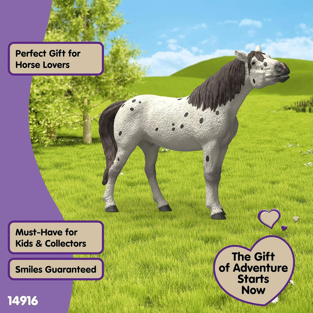 Leopard-spotted horse toy figure with black mane and tail, standing outdoors.