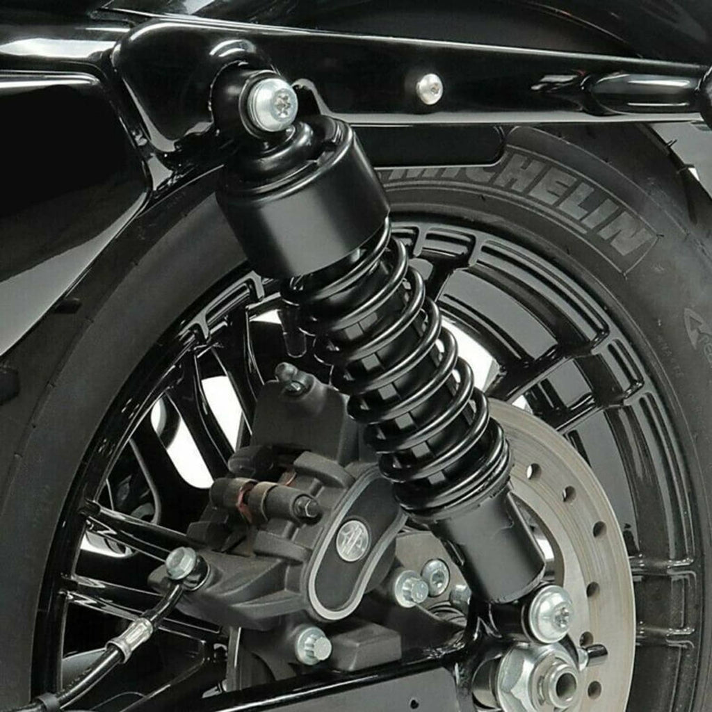 Rear wheel area with black coil shock absorber and mounting bracket details