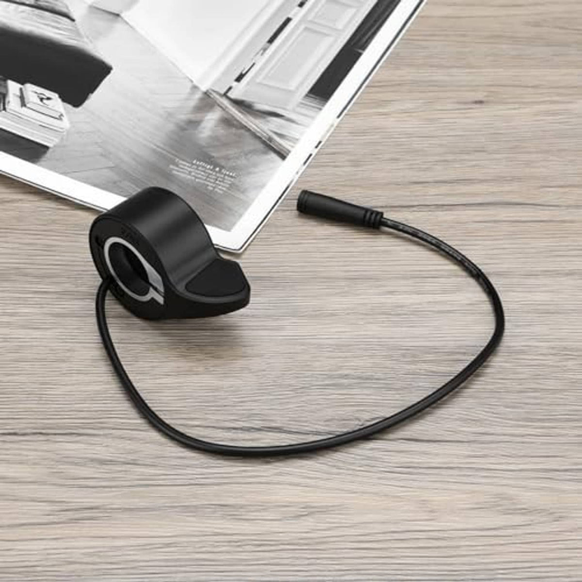 Black thumb throttle speed control with textured thumb lever and coiled cable