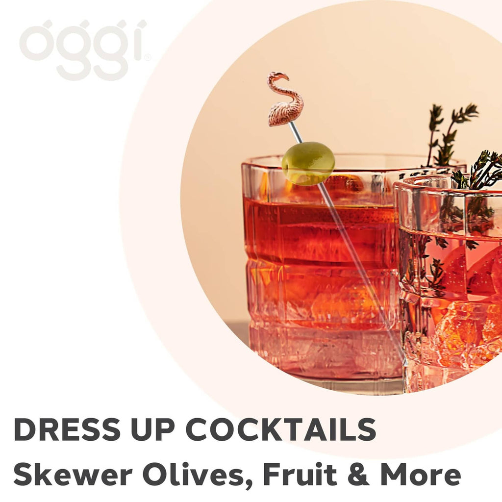 Flamingo cocktail pick with metal skewer on an olive-topped drink