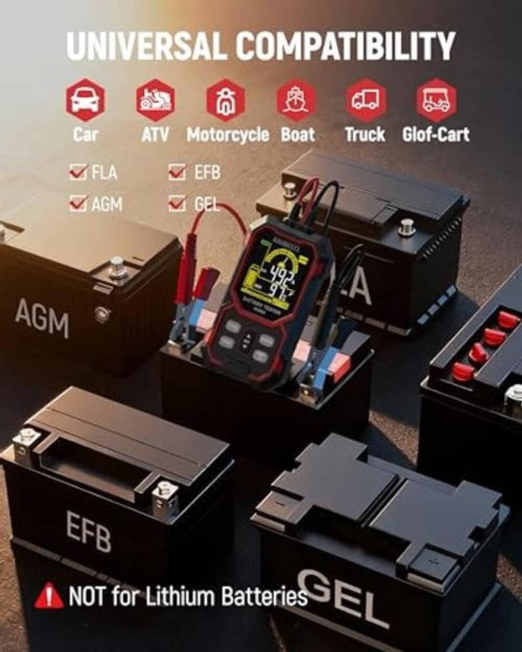 Car battery tester on bench with clamp leads and LCD screen, red-and-black case