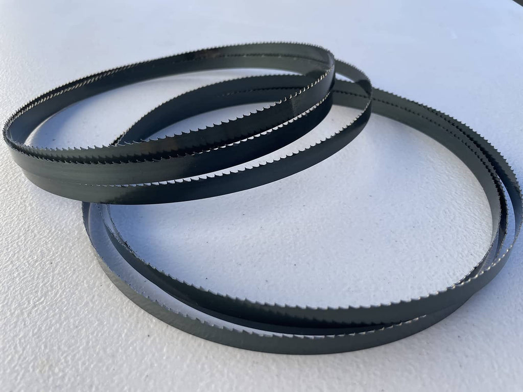 Dark blue wood bandsaw blades, two coiled rings lying side by side