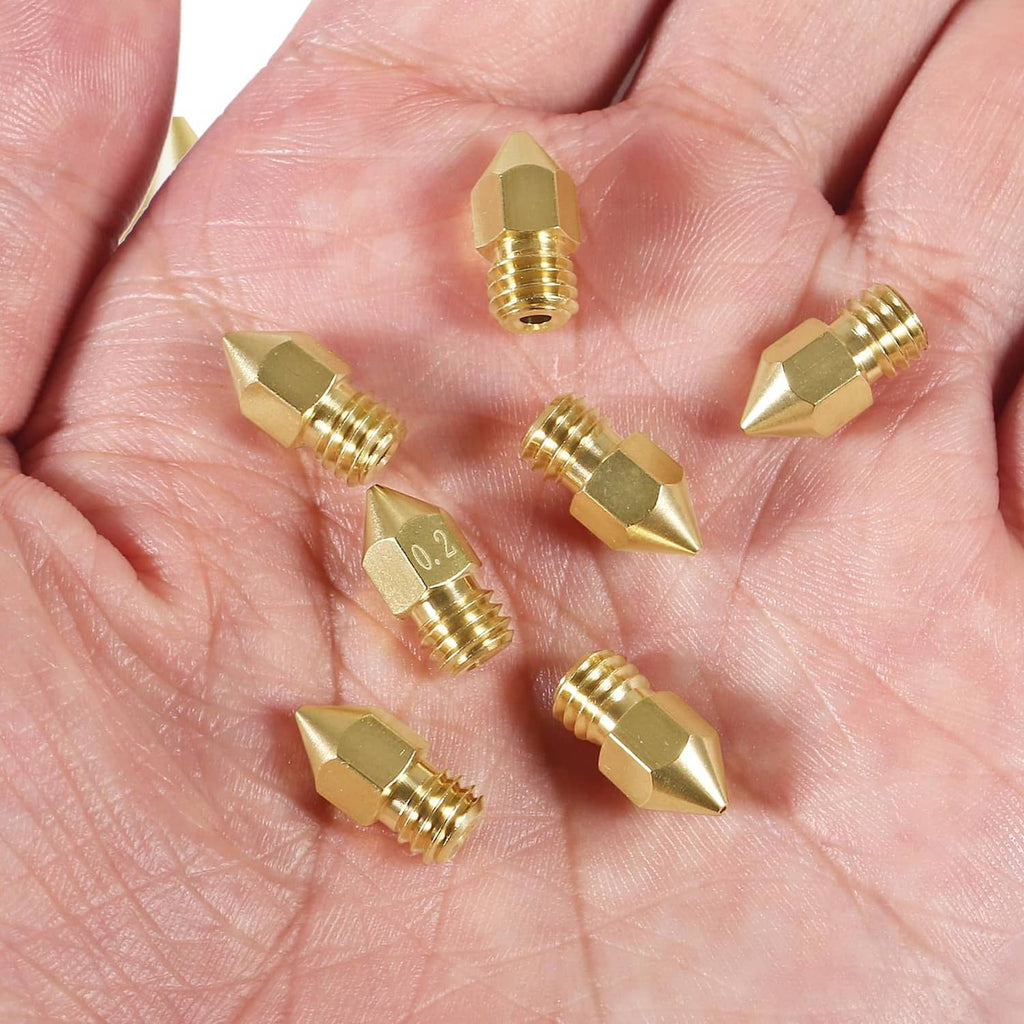 Brass 0.2mm MK8 extruder nozzles in hand, multiple tips with threaded base