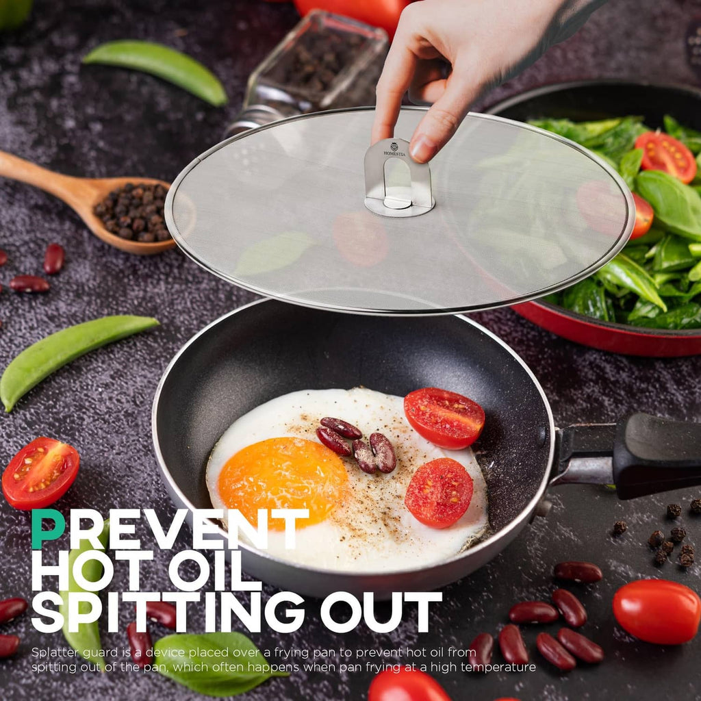 Round stainless splatter screen with central handle over a skillet
