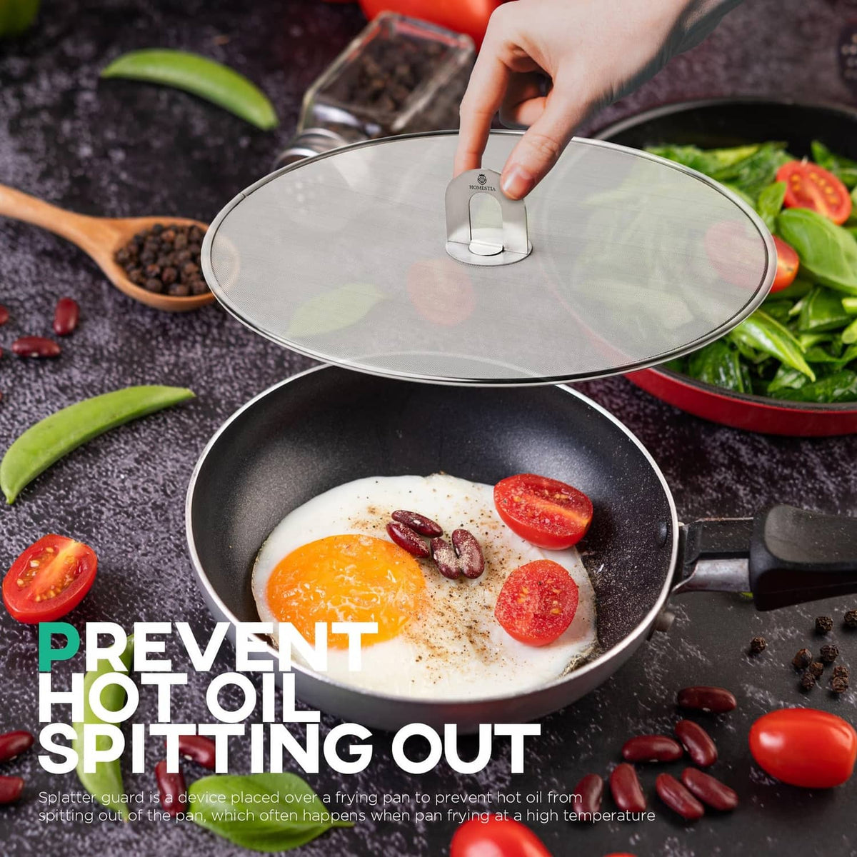 Round stainless splatter screen with central handle over a skillet