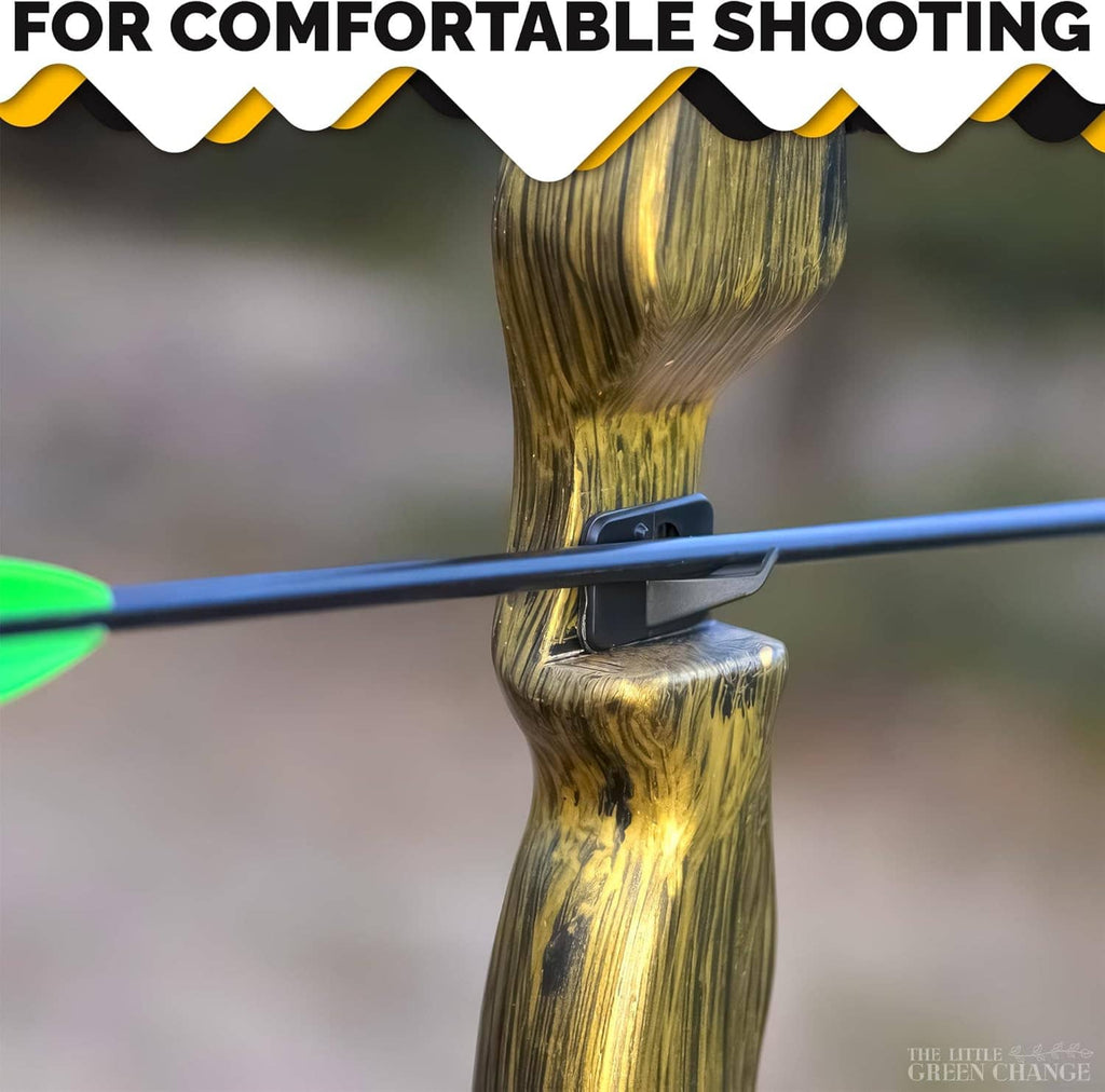 Arrow resting on a black recurve bow arrow rest mounted on a wooden riser