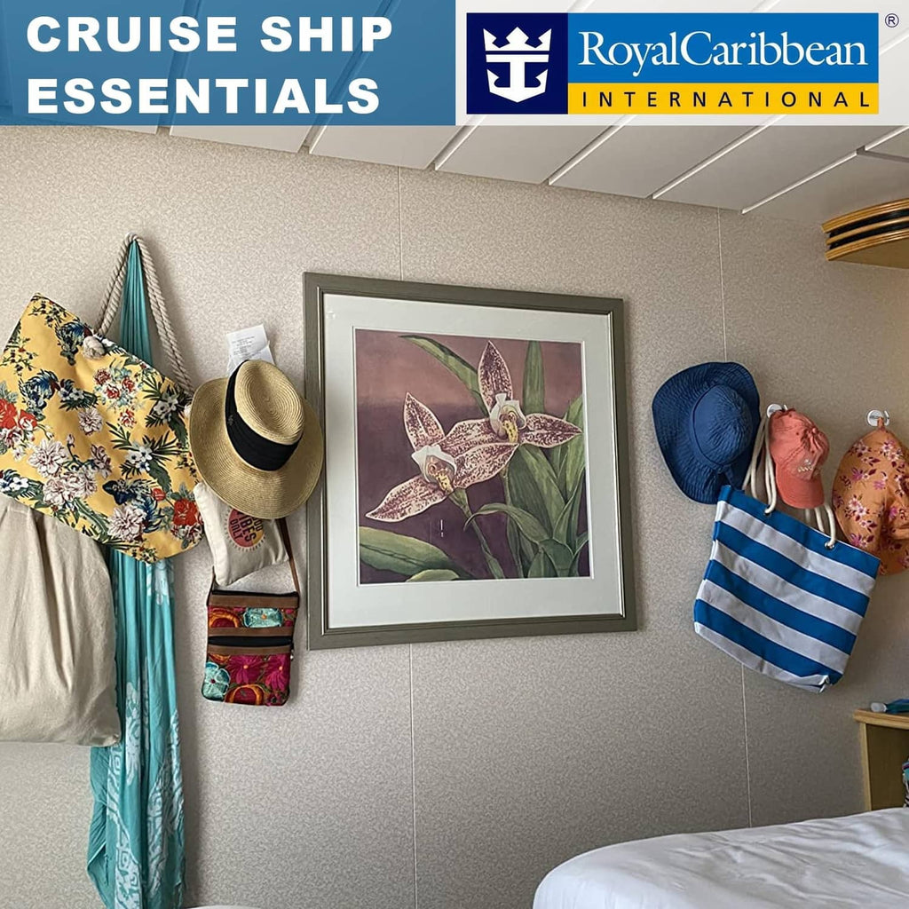 Magnetic hooks holding cruise accessories on cabin wall: hats, bags, and towels