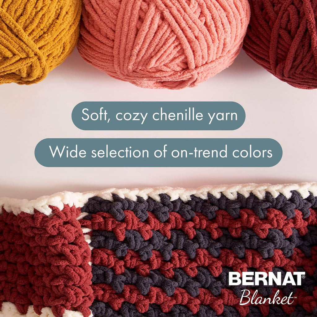 Super bulky chenille yarn strands in rust, coral pink, and mustard yellow