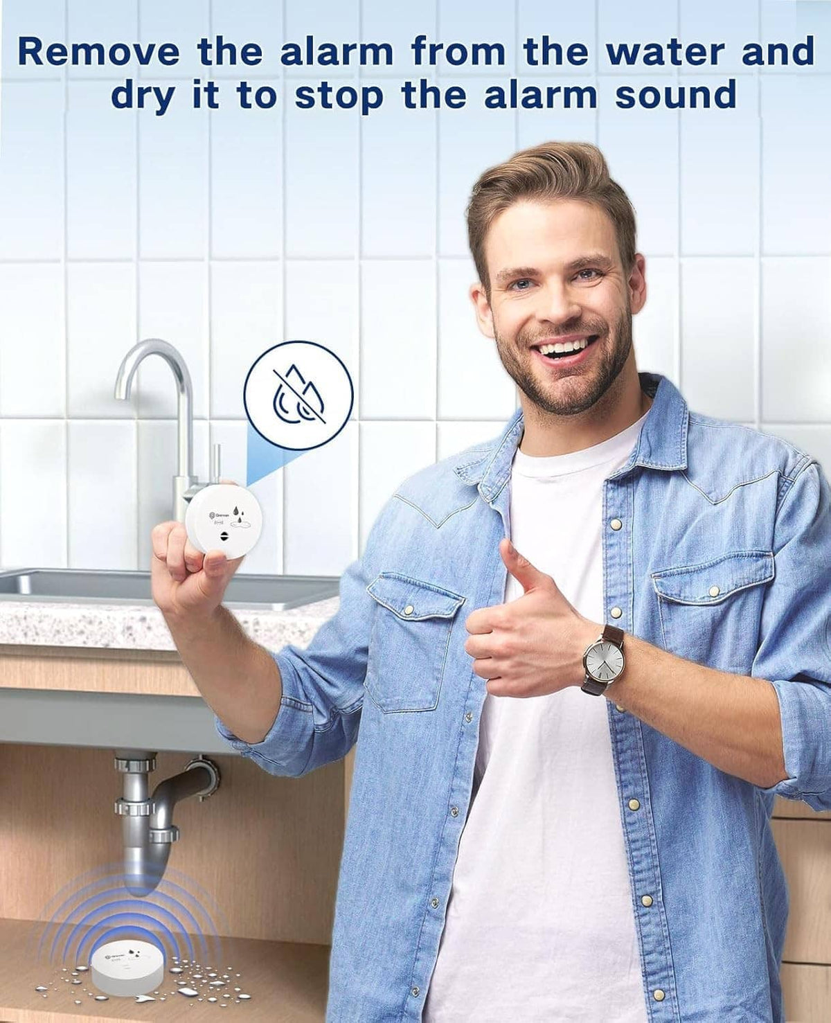 Man holding a small white water leak alarm near a bathroom sink