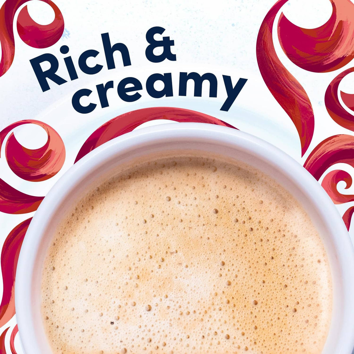 Frothy cappuccino in a cup with 'Rich & creamy' foam surface and swirl accents