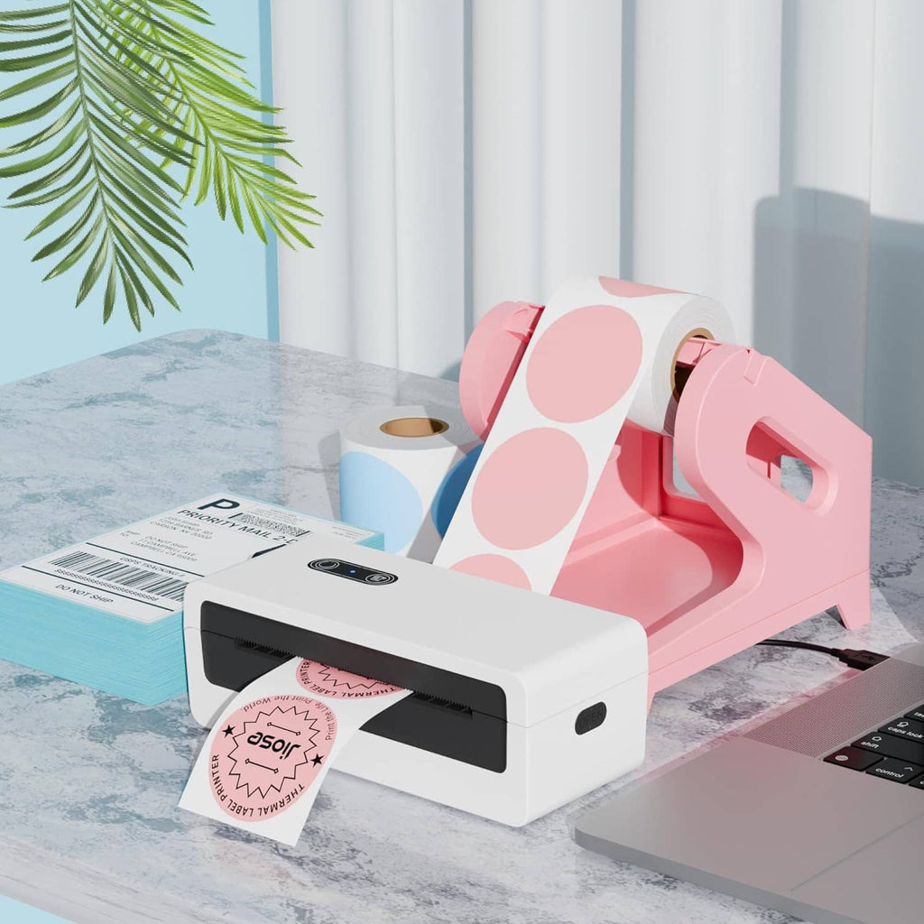 Pink label holder with white thermal printer on desk with label sheets