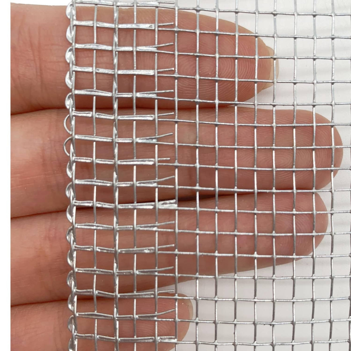 Silver galvanized hardware cloth mesh with square grid held by hand