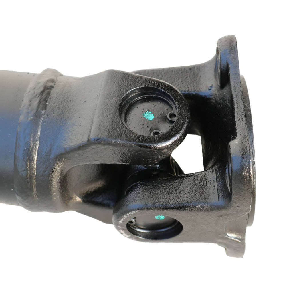 Rear driveshaft U-joint area with blue-gray yoke and black bearing cap, mounting ring