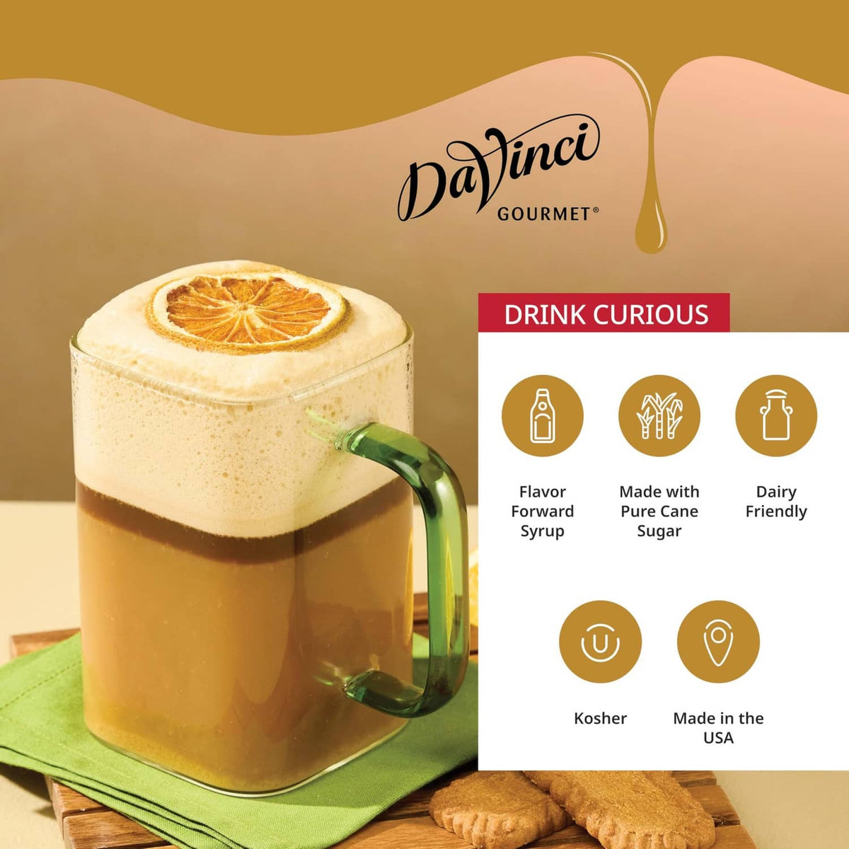 Cookie butter syrup latte in a clear mug with cookie garnish and green spoon