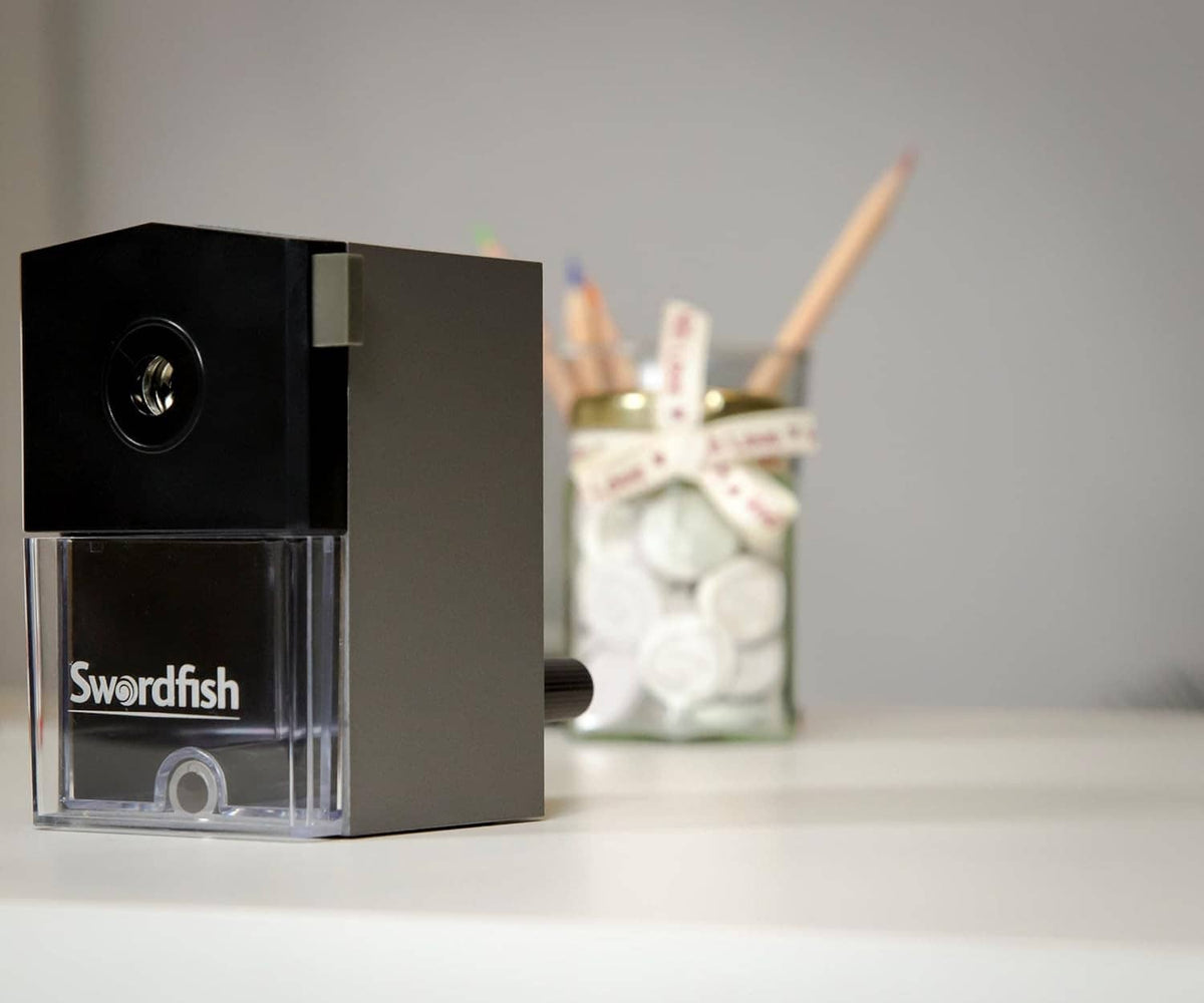 Black manual pencil sharpener with clear shavings bin and front logo window