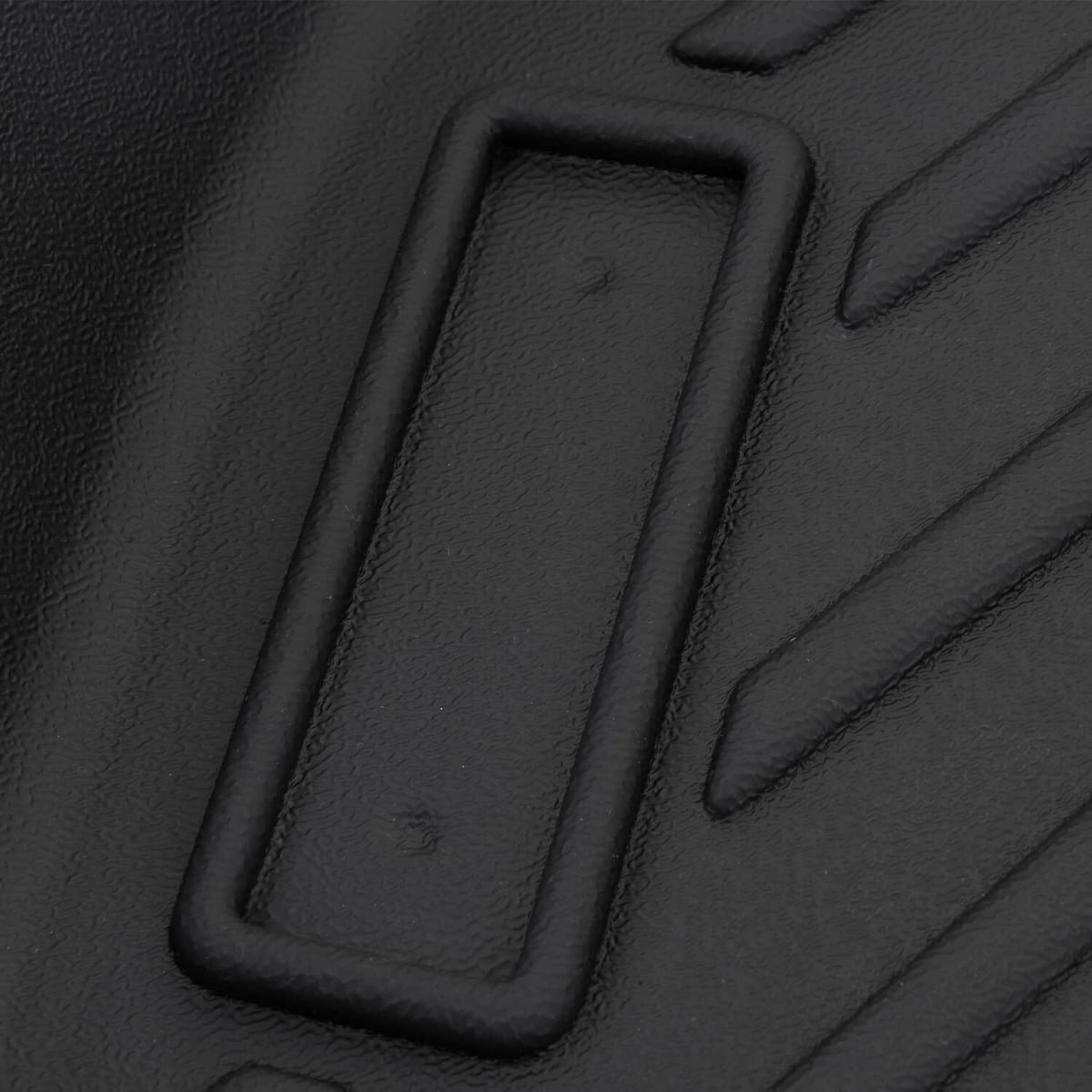 Black TPE floor mat close-up with rectangular retention slot for mounting and stability