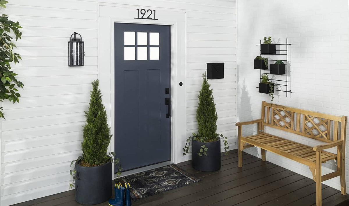 Dark navy front door with satin finish, entryway with bench and planters