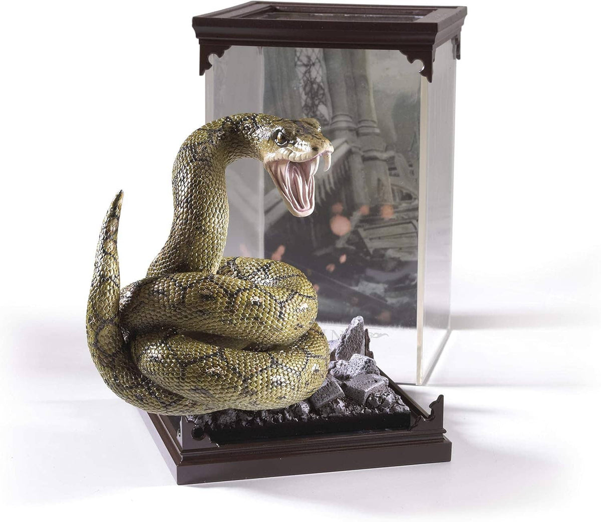 Coiled Nagini snake figurine in clear display case with dark base