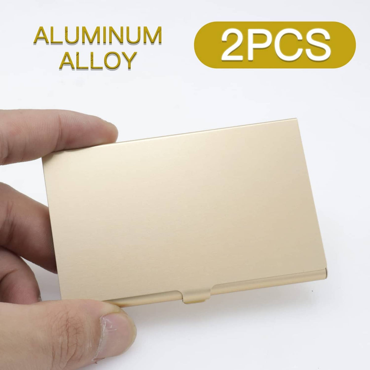 Gold aluminum business card holder held in hand, slim closed case with hinge bar