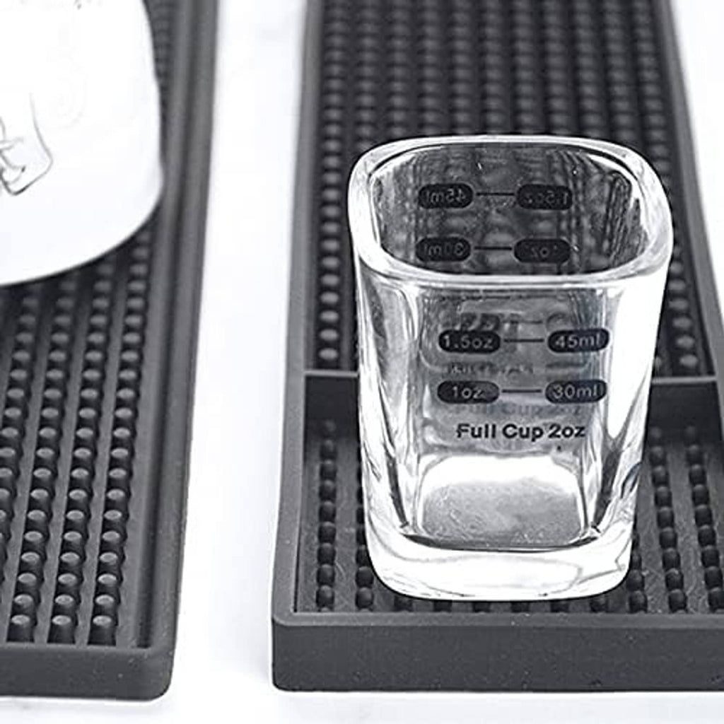 Black rubber bar mat with raised dot texture and cup wells for glassware