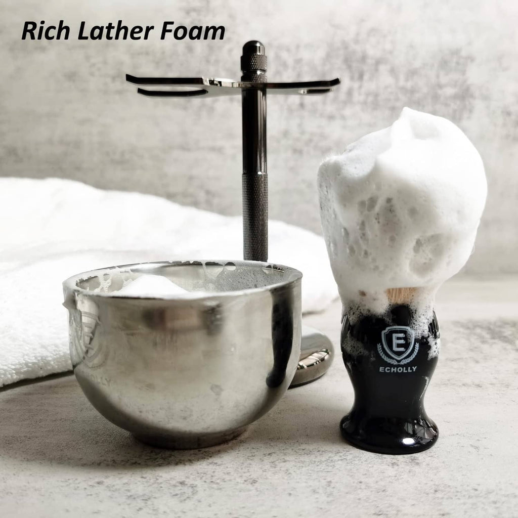 Men's black shaving brush beside rich lather and shaving bowl, glossy handle