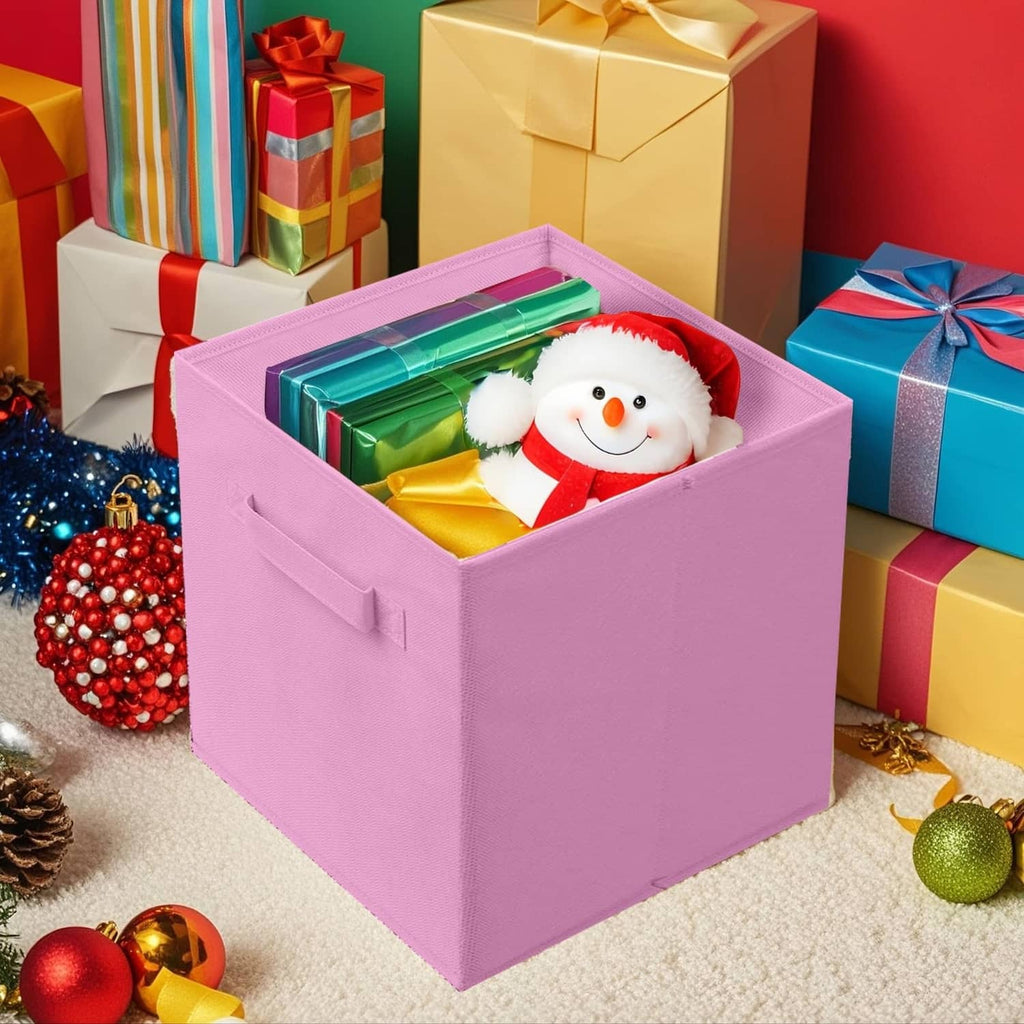 Pink foldable storage cube with side handle, holding stuffed toys and gifts