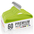 Set of 60 vibrant green velvet hangers with metal hooks, stacked in a box