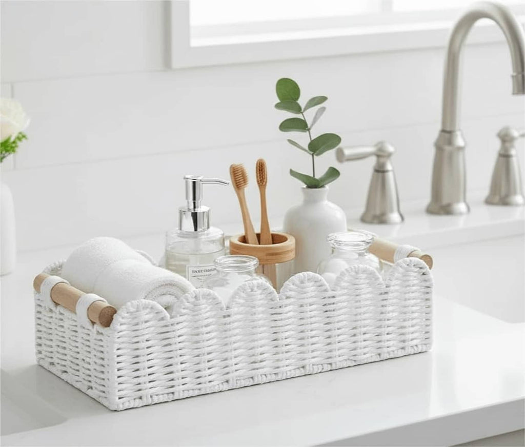 White wicker toilet paper storage basket with scalloped edge and wood side handles