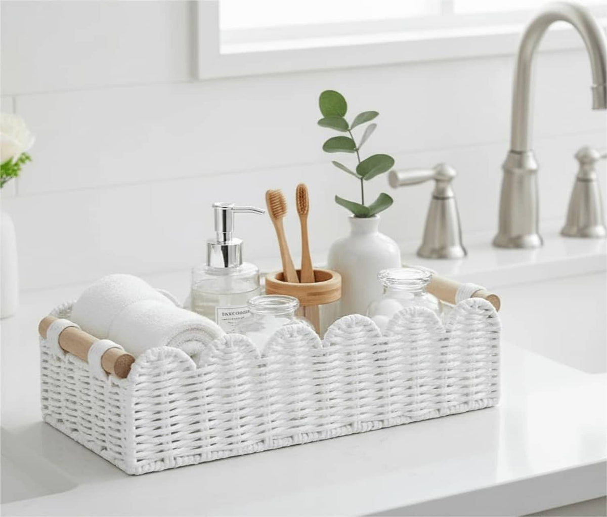 White wicker toilet paper storage basket with scalloped edge and wood side handles