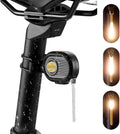 Black LED bike tail light on seatpost with bright amber light and mounting strap