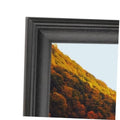 Black solid wood picture frame with beveled inner edge and glass opening.