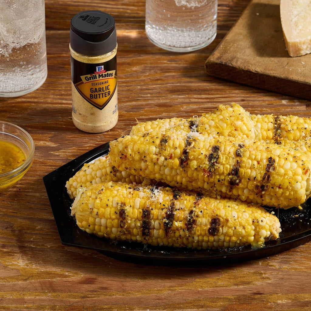 McCormick Grill Mates Garlic Butter seasoning bottle with grilled corn