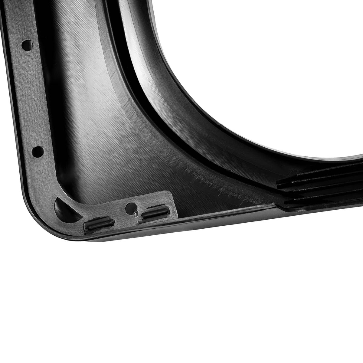 Close-up of black plastic fender cap underside with ridges and mounting points